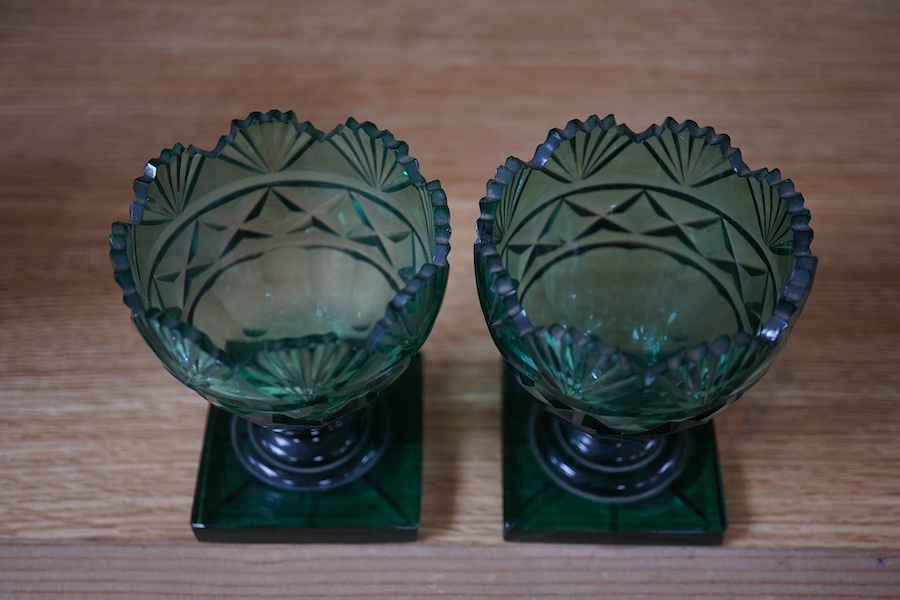 A pair of Regency dark green glass fan cut salts, on square plinths, 9cm. Condition - good, one small chip